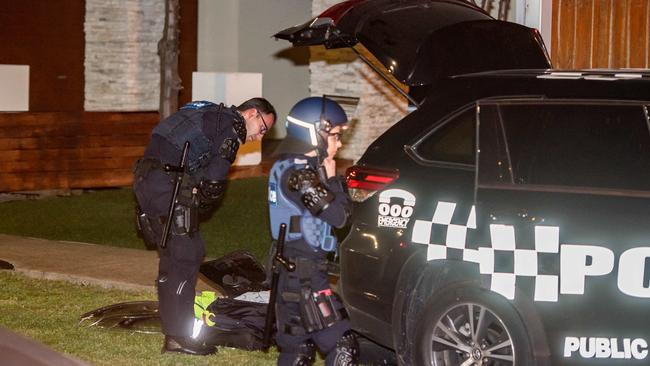 Police, some in riot gear, gathered near Lonzo Park in Taylors Hill. Picture: Jason Edwards.