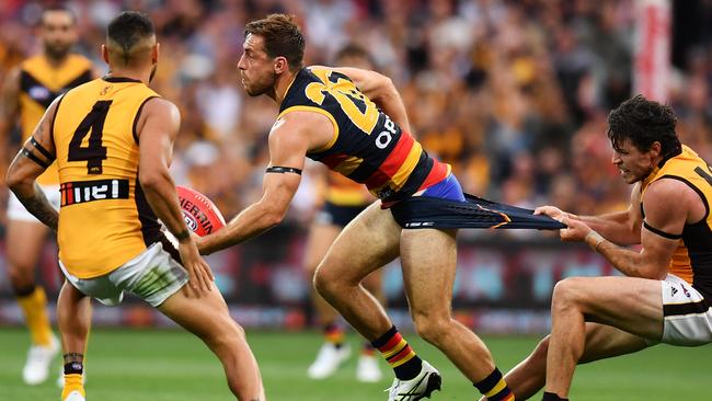 Isaac Smith goes to great lengths to stop Adelaide’s Richard Douglas. Picture: Getty Images