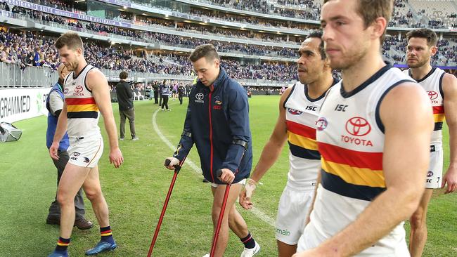 Luke Brown hobbles off Optus Stadium after the Crows’ loss to Fremantle, joining an already long casualty list. Picture: Paul Kane/Getty Images