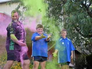 GETTING COLOURED: Sergeant Greg Caletti with Charlie and Cameron Brazier. INSET: The glimpse at the course map for this year's Senex ColourXplosion. Picture: Ellen Ransley