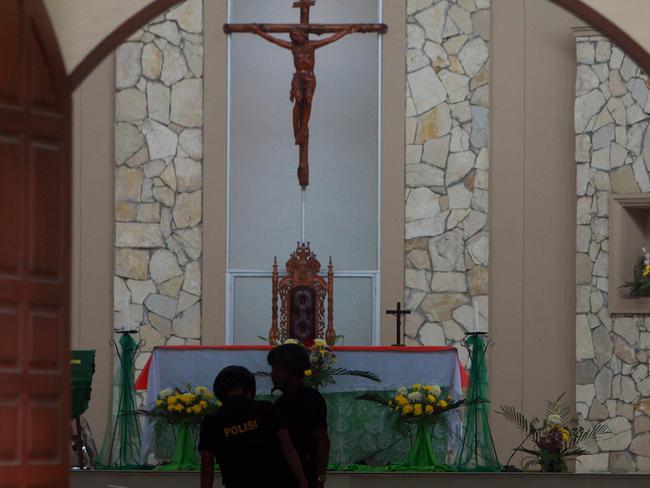 Indonesian policemen examine the Santo Yosef church after a man tried to attack a priest in Medan on August 28, 2016. Picture: AFP.