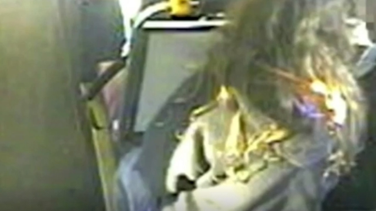 The woman appears to reach over and set the schoolgirl’s hair alight. Picture: Nine News Adelaide