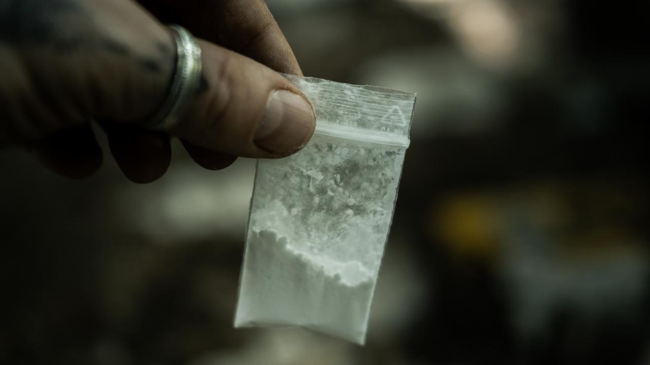 Generic crime Istock - Man holding in hands small bag with cocaine