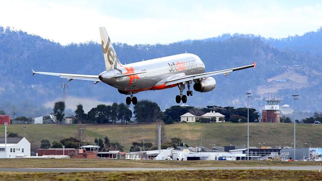 SUNTAS: Generic shots of planes taking off or coming into land, at Hobart Airport. a Jetstar plane landing