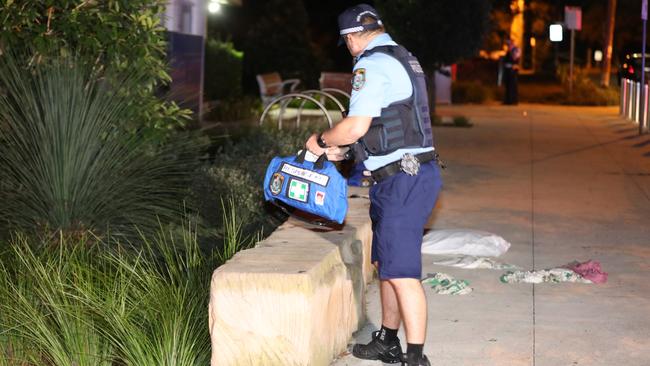 Police comb the crime scene for clues. Picture: Dean Asher