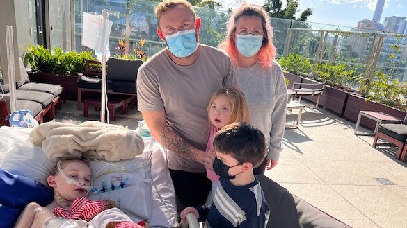 Lilli Unsworth's family visits her on a sunny day in hospital.