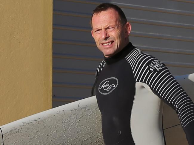 Ex Prime Minister Tony Abbott goes for a surf at North Steyne before coffee with friends .pic John Grainger