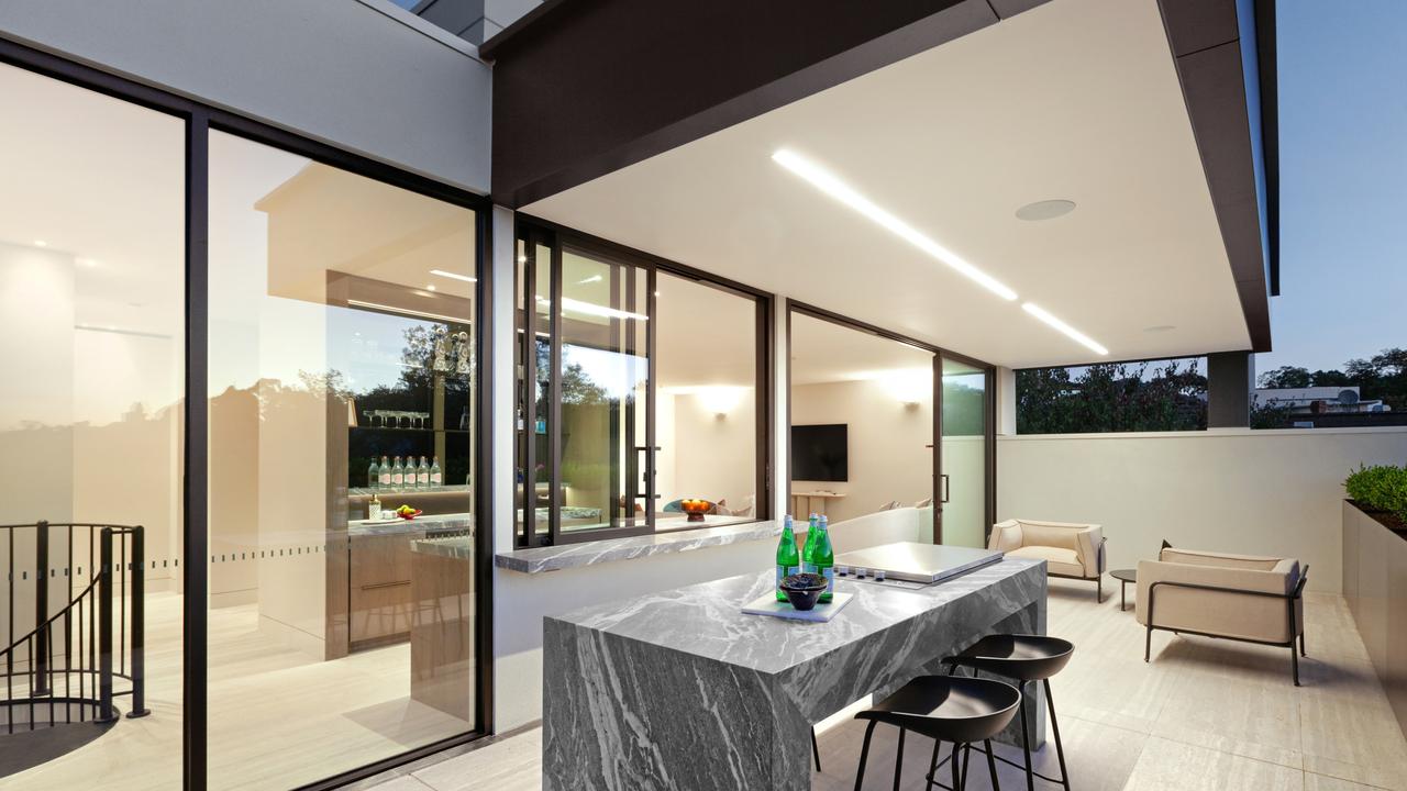The rooftop bar and entertaining terrace offer sweeping city skyline views, complete with a full kitchen, marble bar and integrated barbecue.