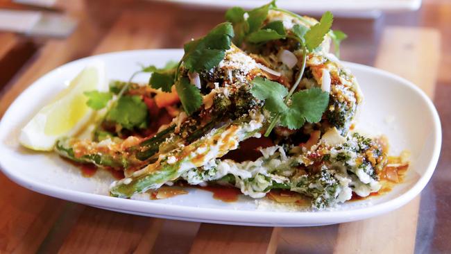 Yulli's Korean fried broccolini with sticky chilli sauce, toasted coconut and crushed almonds. Picture: Supplied