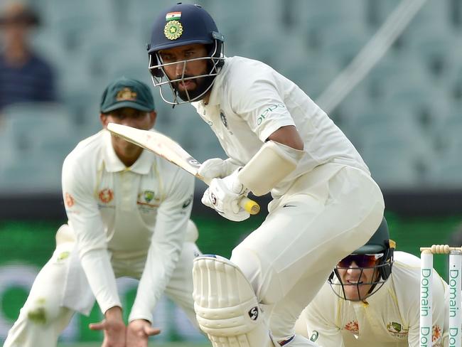 India's batsman Cheteshwar Pujara (C) bats against Australia during day three of the first Test cricket match at the Adelaide Oval on December 8, 2018. (Photo by Peter PARKS / AFP) / IMAGE RESTRICTED TO EDITORIAL USE - STRICTLY NO COMMERCIAL USE