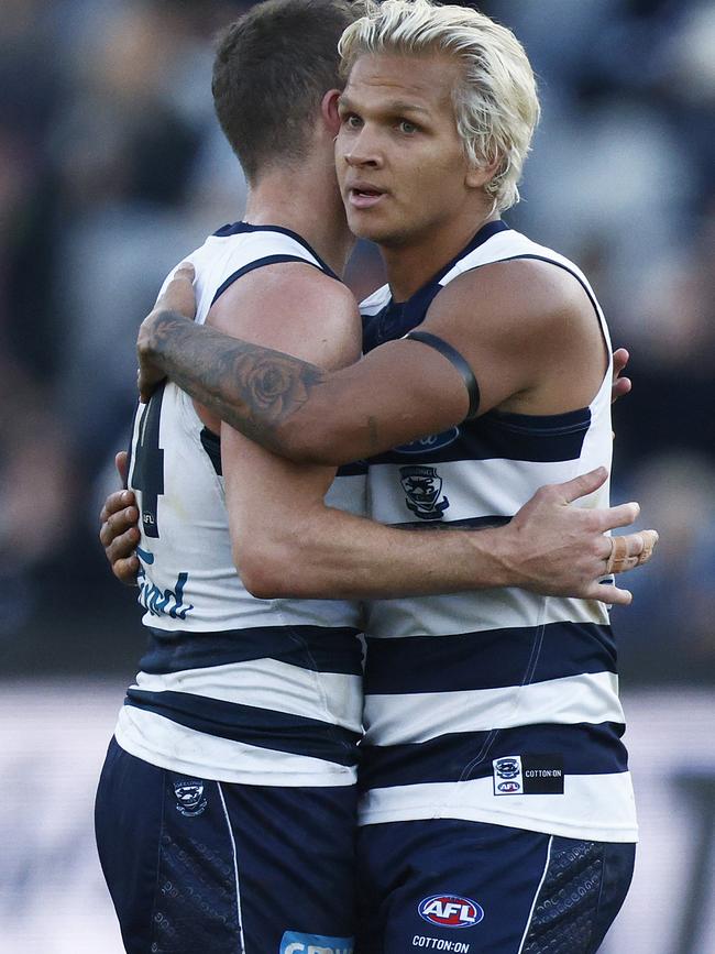 Quinton Narkle celebrates a victory with Joel Selwood.