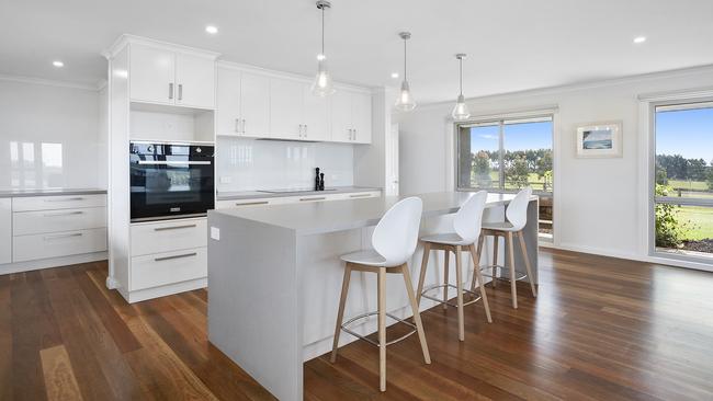 The modern kitchen has a walk-in pantry for extra storage.