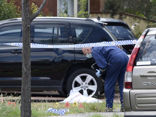 Investigators search for evidence at the site. Picture: Andrew Henshaw