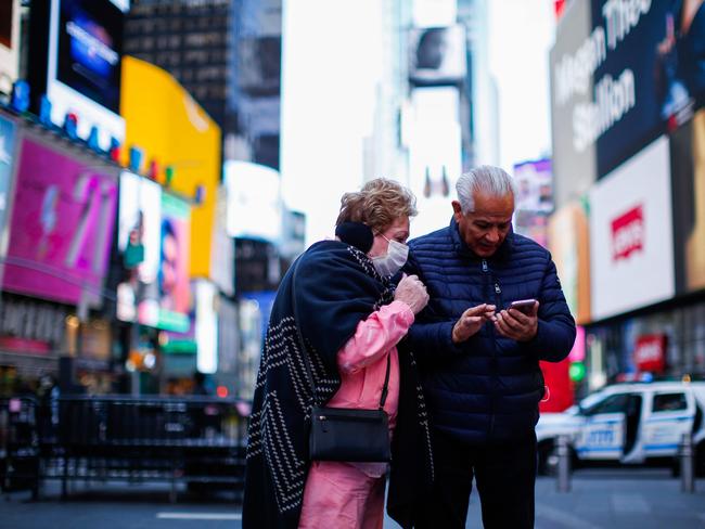 A woman and man visiting Times Square in New York City. Picture: Kena Betancur/AFP