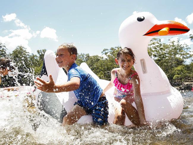 TJ Ryan, 5, and Tynisha Ryan, 9, cooling off at Paramatta Lake. Picture: Justin Lloyd