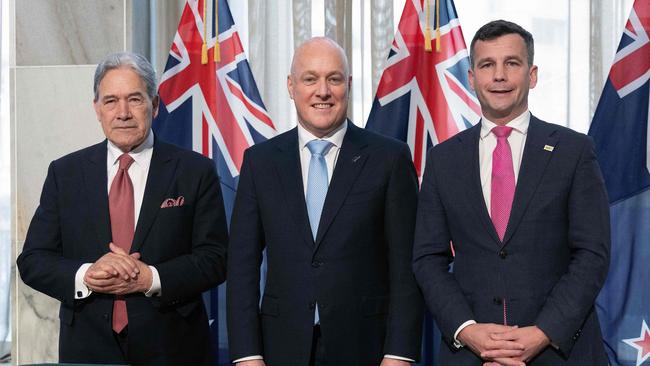 (L-R) Winston Peters, leader of New Zealand First party, New Zealand's incoming Prime Minister Christopher Luxon, and David Seymour, leader of the ACT New Zealand party, attend the signing of an agreement to form a three-party coalition government at Parliament in Wellington.