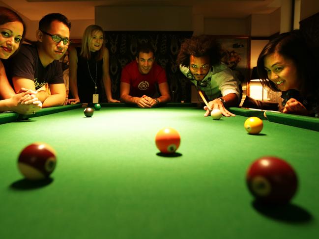 Atlassian is a software development company that places a premium on having mates at work. Their office is designed with a level for workers to play table tennis, poker, wi and it also has a lollie shop and a beer tap. Ruth Kapea, Kelvin Yap, Sam Thebridge, Seb Ruiz, Sten Pittet, Anna Dominguez enjoy a game of pool in the common room area for its workers.