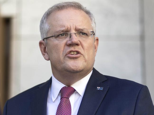 Prime Minister Scott Morrison with the Treasurer Josh Frydenberg and the Chief Medical Officer Brendan Murphy during a press conference at Parliament House in Canberra. Picture Gary Ramage