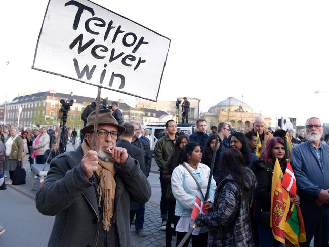 A man holds up a sign reading "Terror never win" as he attends a commemoration event by the youth parties for the victims of the bomb attacks in Sri Lanka, in Copenhagen, Denmark. Picture: AFP