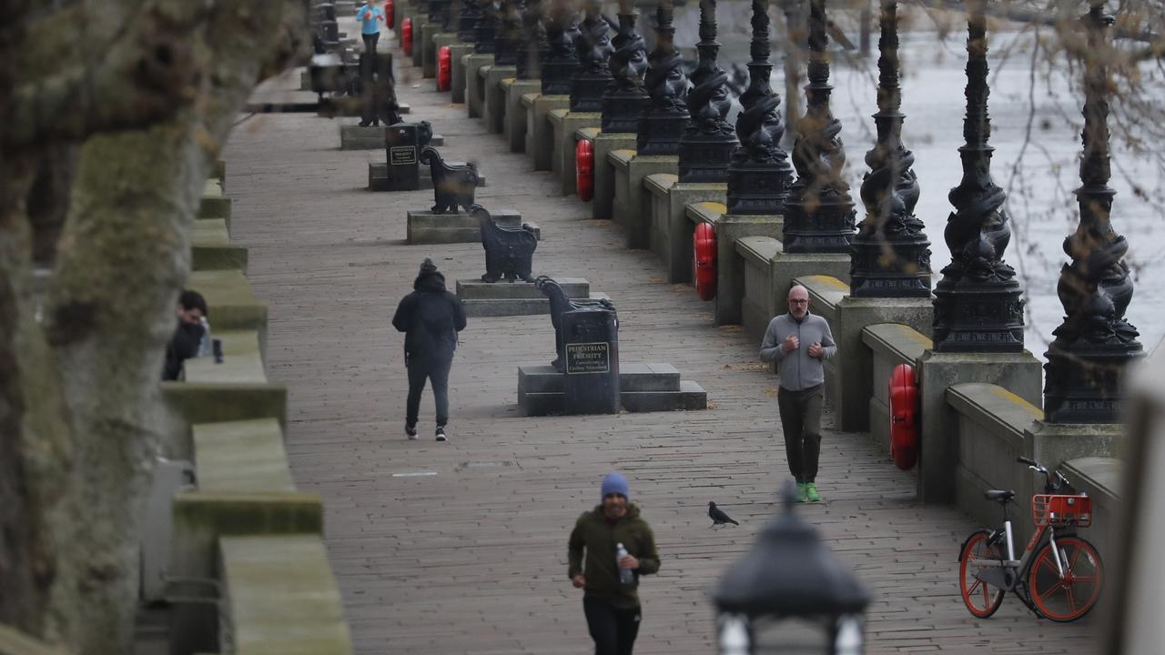 Joggers and pedestrians alongside the River Thames practise social distancing to help prevent the spread of the coronavirus in London. Picture: Frank Augstein/AP