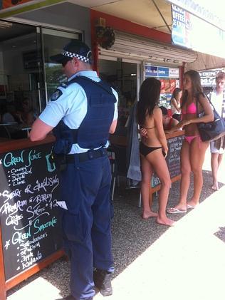 Police attend a snack bar following a brawl between rival bikies groups on the Gold Coast.