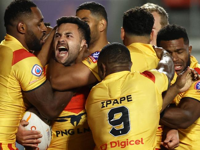 ST HELENS, ENGLAND - OCTOBER 18: Rhyse Martin of Papua New Guinea celebrates their sides first try with team mates during Rugby League World Cup 2021 Pool D match between Tonga and Papua New Guinea at Totally Wicked Stadium on October 18, 2022 in St Helens, England. (Photo by Michael Steele/Getty Images)