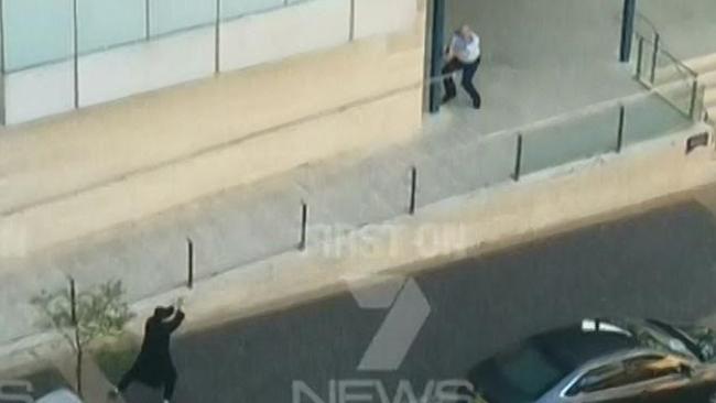 Farhad Khalil Mohammad Jabar opens fire at Special Constables. Moments before, he shot down Mr Cheng. Picture: Ch 7