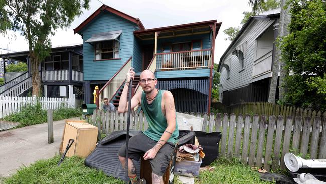 Martin Wright (front) and Will Orrick, with the ruined furniture some from two weeks ago and from yesterday, cleaning up their house at 85 Longlands St Gabba, Flooding Clean Up, Gabba - on Sunday 15th December 2024 - Photo Steve Pohlner