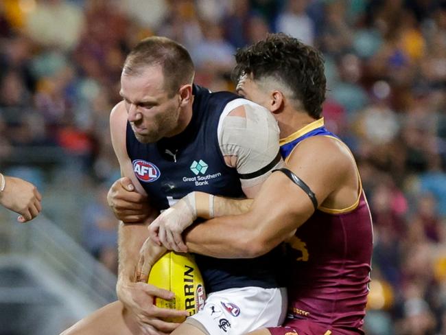 BRISBANE, AUSTRALIA - MARCH 08: Sam Docherty of the Blues is tackled by Cam Rayner of the Lions during the 2024 AFL Opening Round match between the Brisbane Lions and the Carlton Blues at The Gabba on March 08, 2024 in Brisbane, Australia. (Photo by Russell Freeman/AFL Photos via Getty Images)