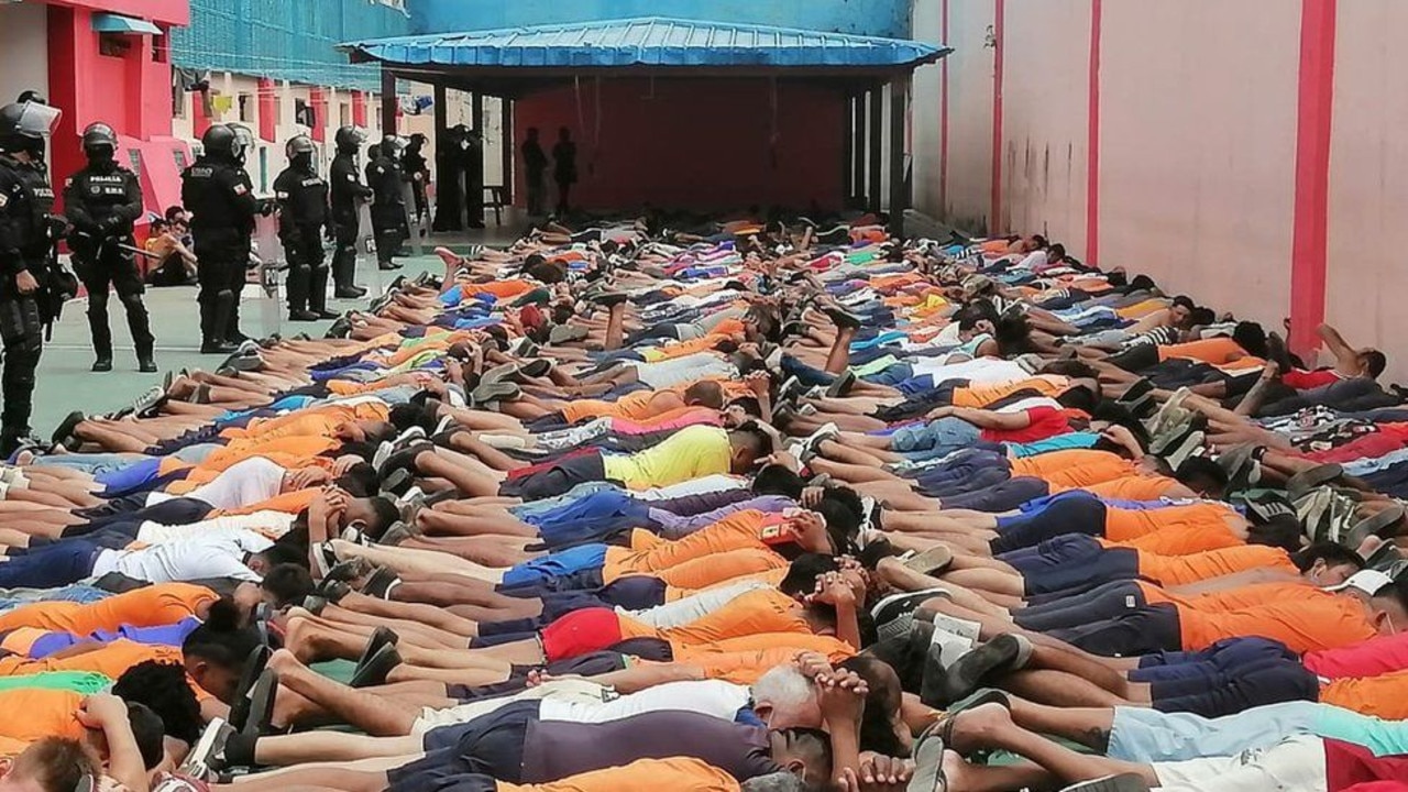 Prisoners are forced to lay down by guards. Picture: Government handout