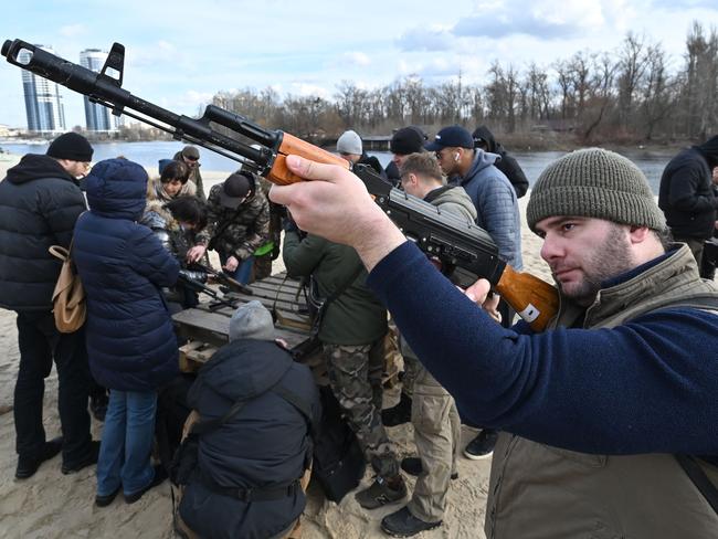 Residents attend an open training organised for civilians by war veterans and volunteers at one of Kyiv's city beaches. Picture: AFP