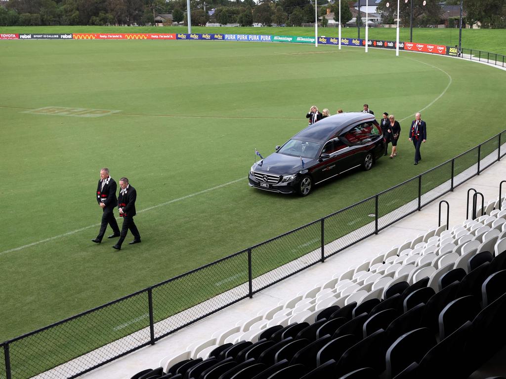 The family of Australian cricket superstar Shane Warne follows the hearse on a lap of the ground after a private memorial service at the St Kilda Football Club in Melbourne on March 20, 2022.