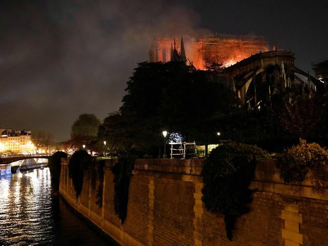 Flames billow from the roof at Notre-Dame Cathedral in Paris on April 15, 2019. - A fire broke out at the landmark Notre-Dame Cathedral in central Paris, potentially involving renovation works being carried out at the site, the fire service said. (Photo by GEOFFROY VAN DER HASSELT / AFP)