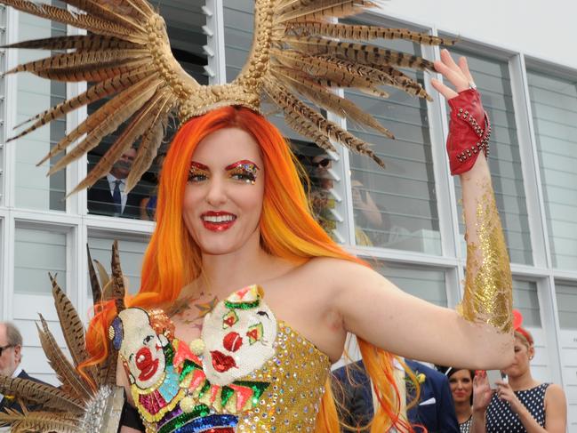 Geoffrey Edelsten (left) is seen standing next to to Gabi Grecko as she holds up her hand with an engagement ring in the Birdcage on Melbourne Cup Day at Flemington Racecourse in Melbourne, Tuesday, Nov. 4, 2014. (AAP Image/Julian Smith) NO ARCHIVING, EDITORIAL USE ONLY