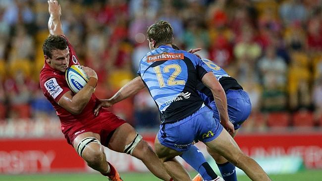 Reds backrower Jake Schatz is hit hard by the Western Force defence on Saturday night.