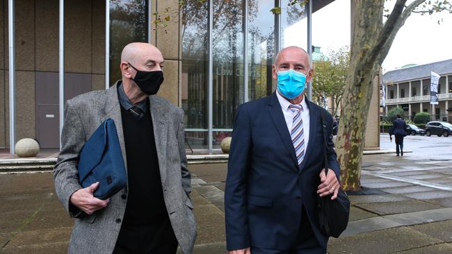 Chris Dawson (right, blue face mask) with his brother outside the court on May 11. NCA Newswire/ Gaye Gerard