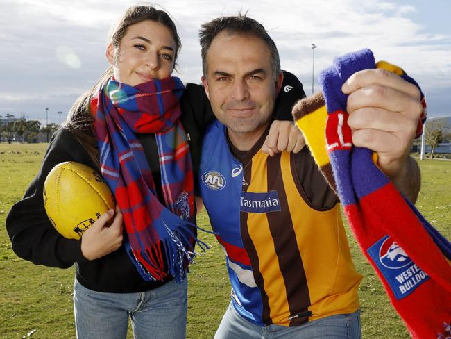 Ex Bulldog and Hawks player Brian Lake, pictured with his daughter Mylee, is torn between his two former teams before Friday night’s elimination final. Picture: Michael Klein