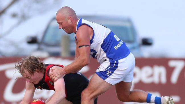 Irrewarra-Beac’s Max Hutchinson falls to the ground in front of South Colac’s Adam Donohue.
