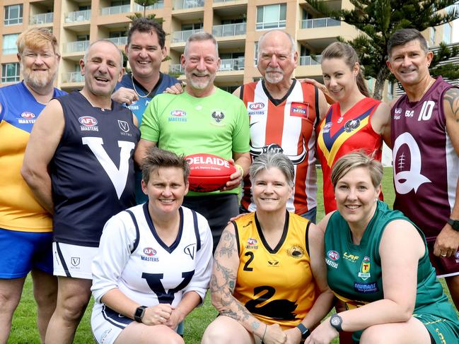 AFL Masters National Carnival being held in Adelaide. Men and women from each state at Colley Reserve, Glenelg. Representatives of the various teams, including (LtoR Front) Belinda Bowey (Victoria Country),  Kirsten Funston, (WA), and  Kristy Douglas (TAS), (LtoR back),  Graeme (Blue) Pocknee, (ACT), Dom Sita (Victoria Metro),  Andrew Pratt, (NSW),   Brendan Corcoran (UMP),  David Lloyd, (NT), Casey Martel (SA), and Danny Niciauskas, (QLD). 23 September 2022. Picture Dean Martin