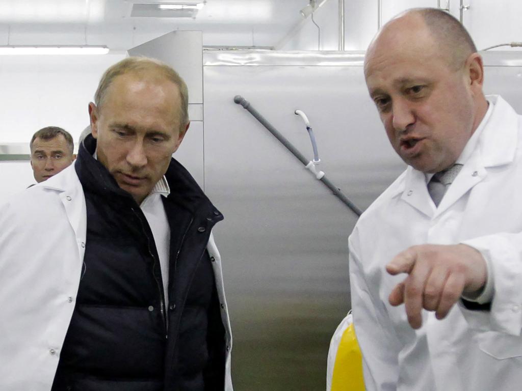 Yevgeny Prigozhin and Russian Prime Minister Vladimir Putin during simpler times. Picture: AFP