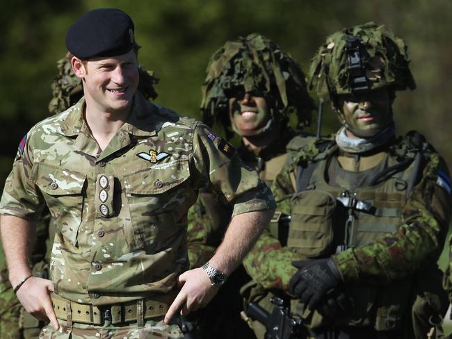 Prince Harry chats with members of the Estonian Scouts Battalion who served in Afghanistan. Picture: Sean Gallup