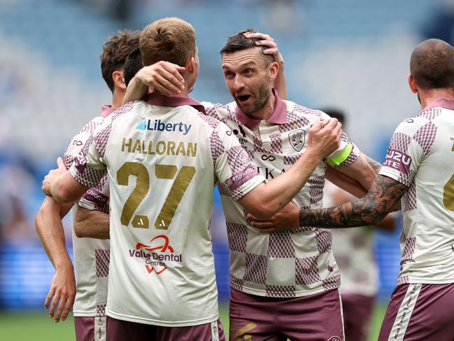 Ben Halloran of the Roar celebrates scoring a goal with team mates. Picture: Getty Images