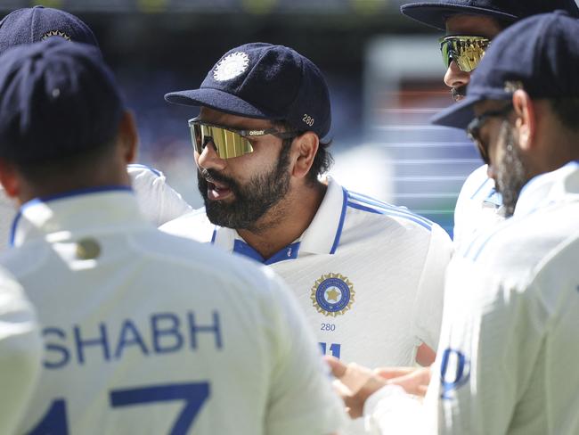 India's Rohit Sharma talks to his teammates before play on day five of the fourth cricket Test match between Australia and India at the Melbourne Cricket Ground (MCG) in Melbourne on December 30, 2024. (Photo by Martin KEEP / AFP)