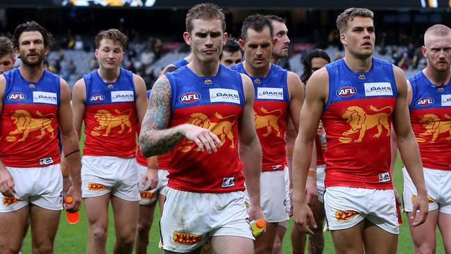 Dayne Beams leads Brisbane off after a loss.