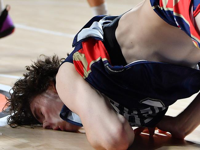 ADELAIDE, AUSTRALIA - JANUARY 17:  Josh Giddey of the 36ers slam dunks and falls and injures his mouth during the round one NBL match between the Adelaide 36ers and the South East Melbourne Phoenix at Adelaide Entertainment Centre, on January 17, 2021, in Adelaide, Australia. (Photo by Mark Brake/Getty Images)