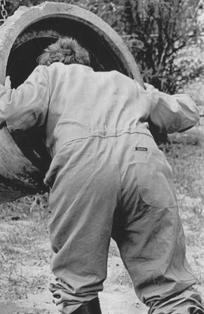 A forensic officer searches a drainage pipe for possible remains in the aftermath of the Birnies’ arrest. Picture: Ernie McLintock