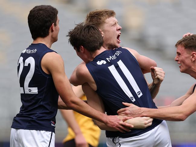 Thomas Sims celebrates a goal with teammates at Optus Stadium. Picture: Paul Kane/AFL Photos/via Getty Images.