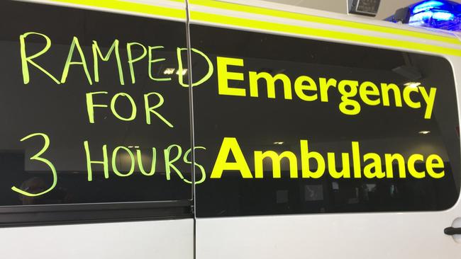 A sign written on the side of a ramped ambulance.