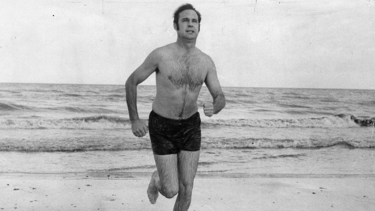 Premier Steele Hall running along the beach at Henley Beach after a swim, in April, 1970.