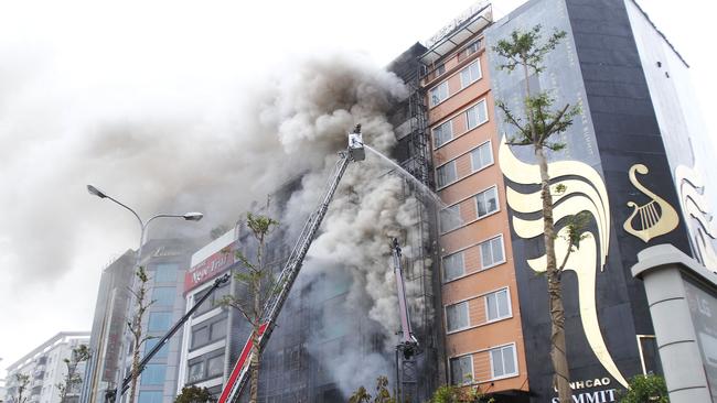 Firefighters battling a fire at a karaoke bar in Hanoi. Picture: AFP